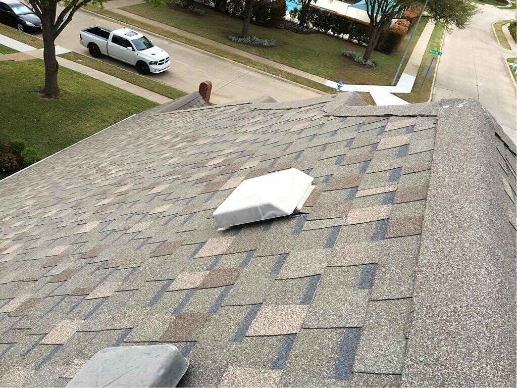 Plano roofing project — shingle field and roof penetration