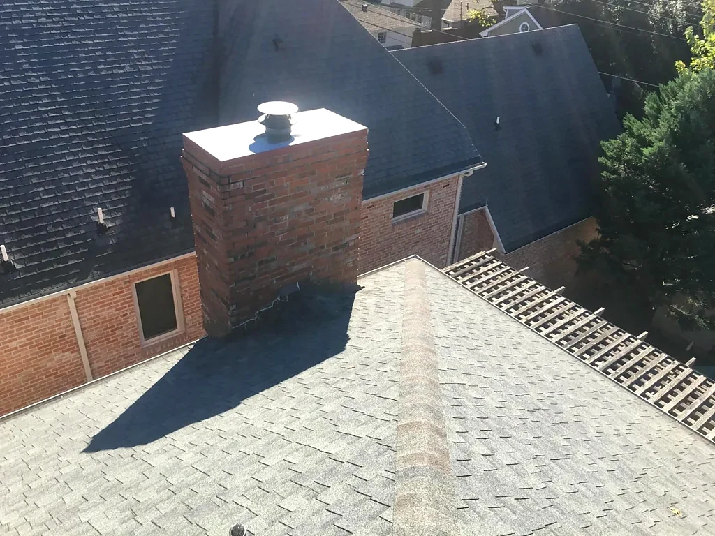 Brick chimney and adjoining roof planes.