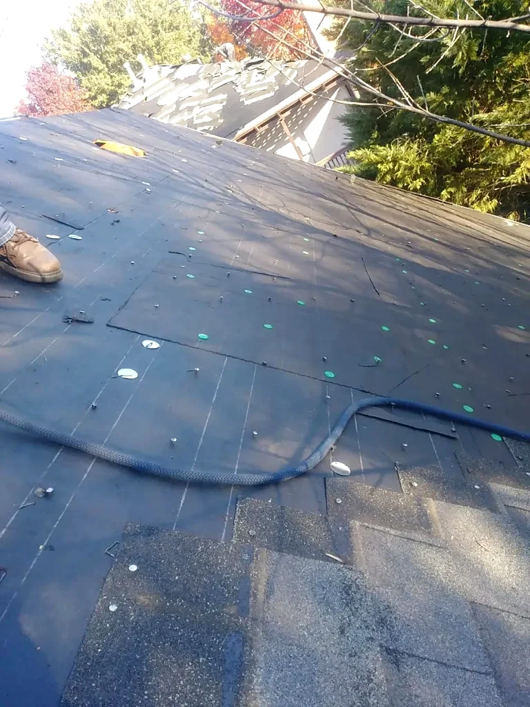 Underlayment and roofing removal during installation.