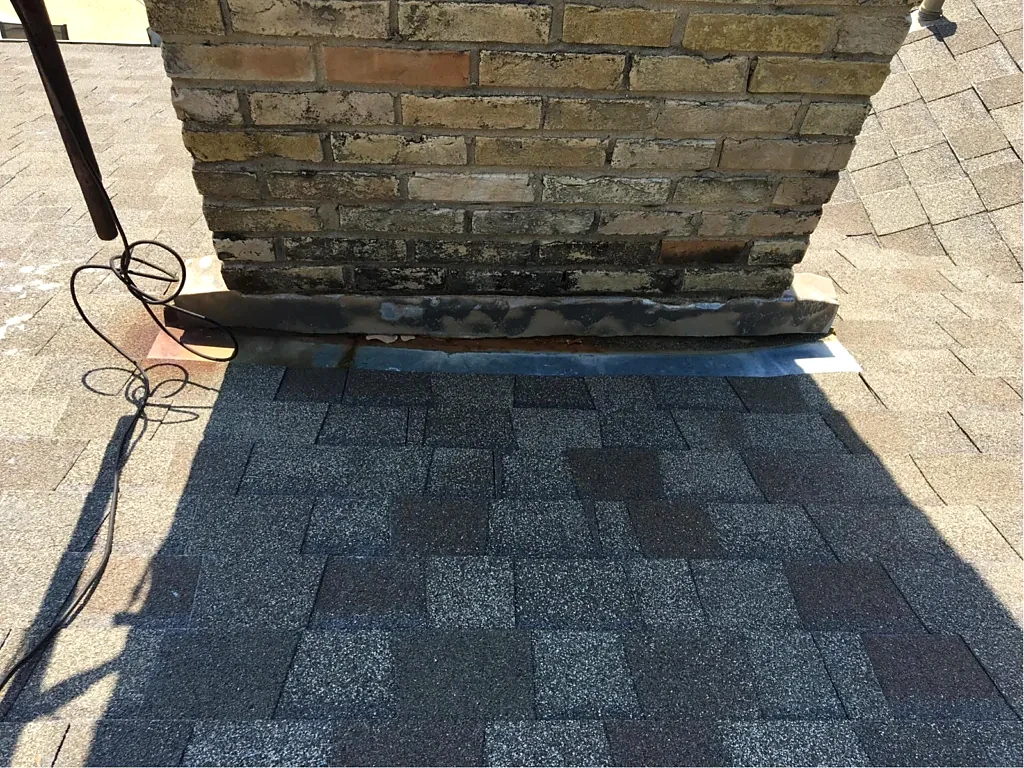 Chimney flashing at the existing roof.