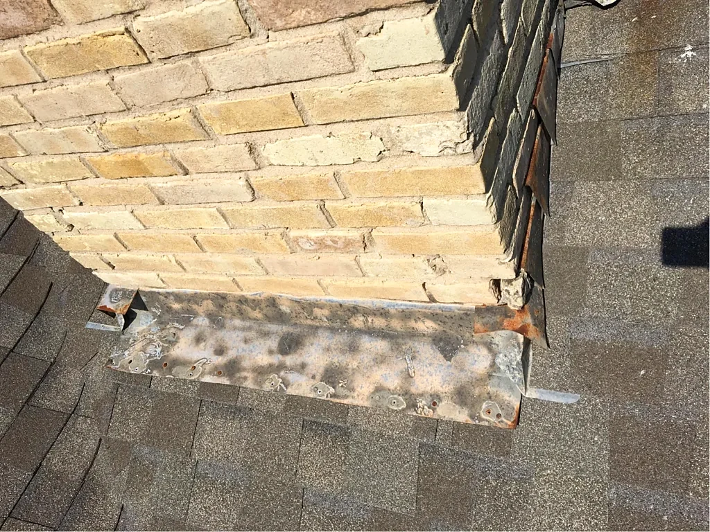Masonry chimney and roof connection.