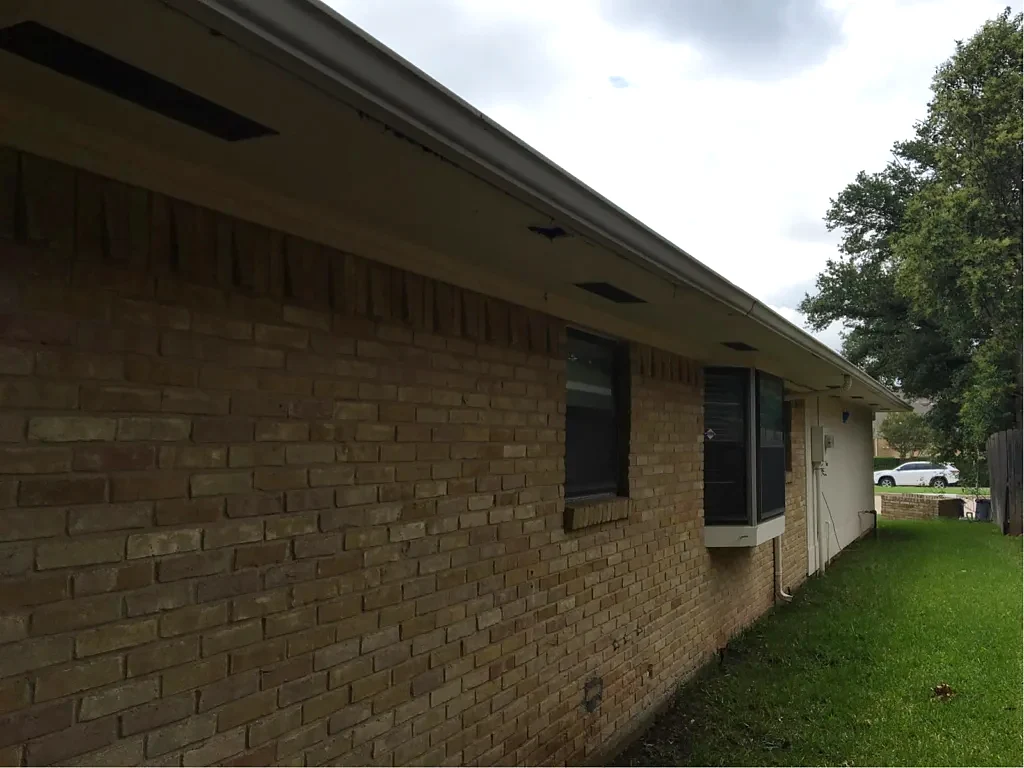 Roof edge and soffit along the brick elevation.