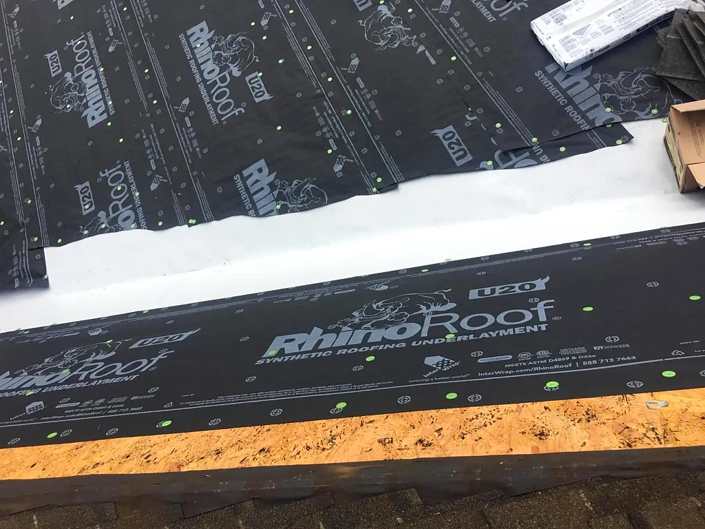 Underlayment and valley protection during roof installation.
