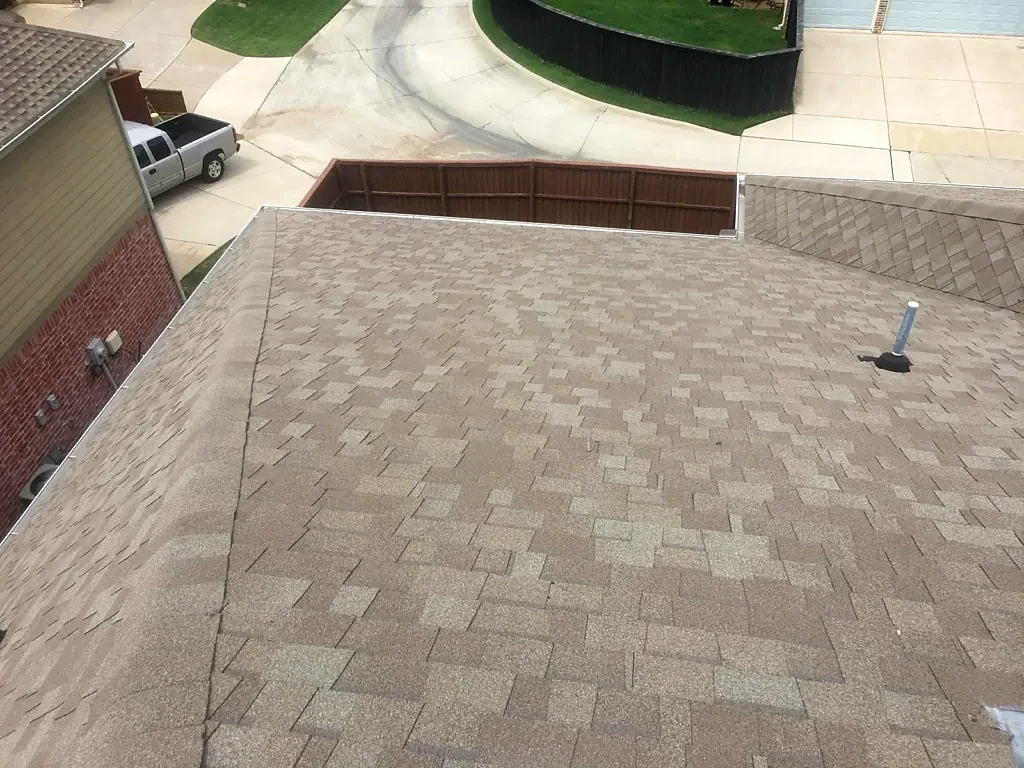 Existing shingle roof and pipe penetration before replacement.