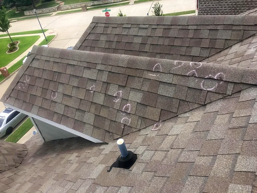 Shingle ridge with inspection markings.