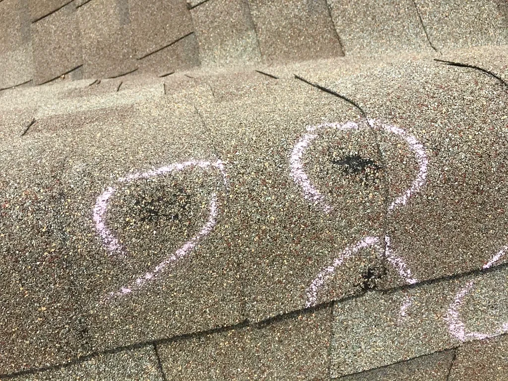 Marked shingle areas before replacement.