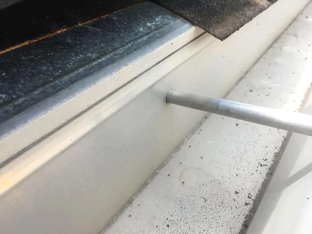 Roof-edge and gutter connection before work.