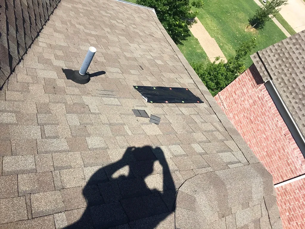 Existing shingles and plumbing vent.