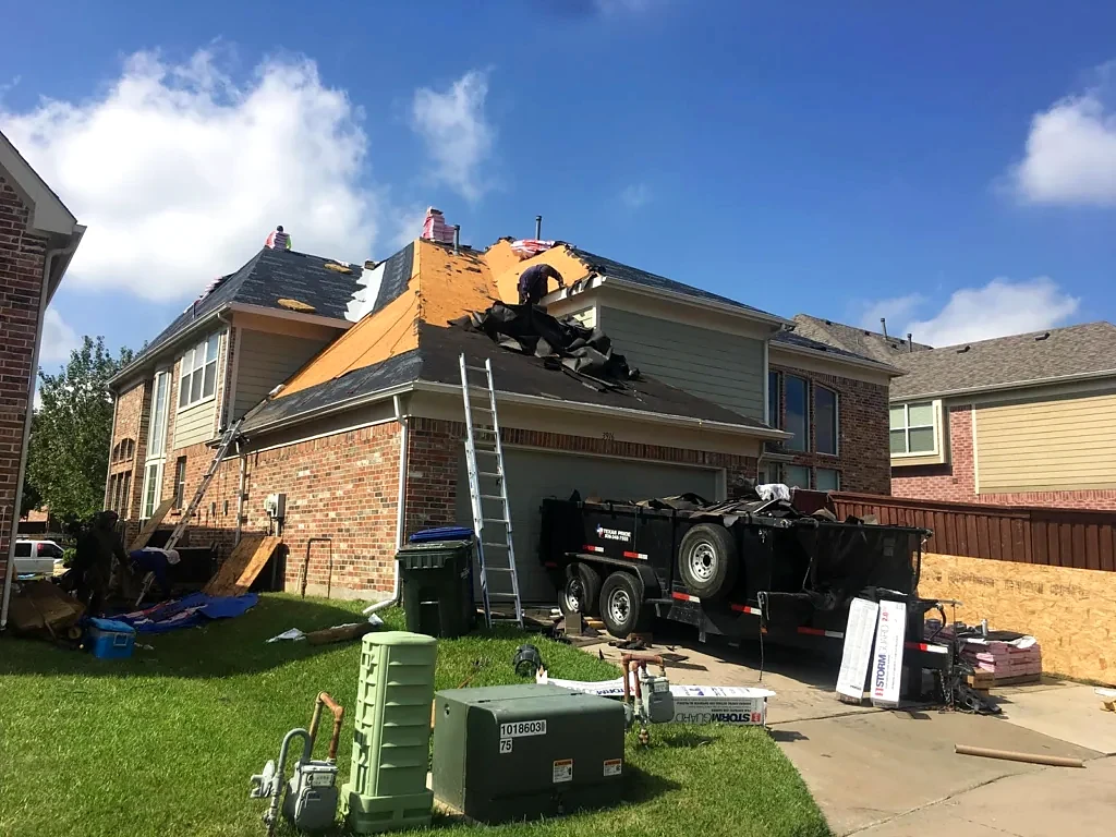 Roof replacement underway above the garage.