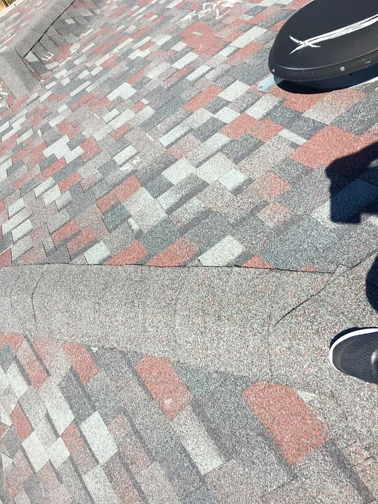 Existing shingles around a roof penetration.