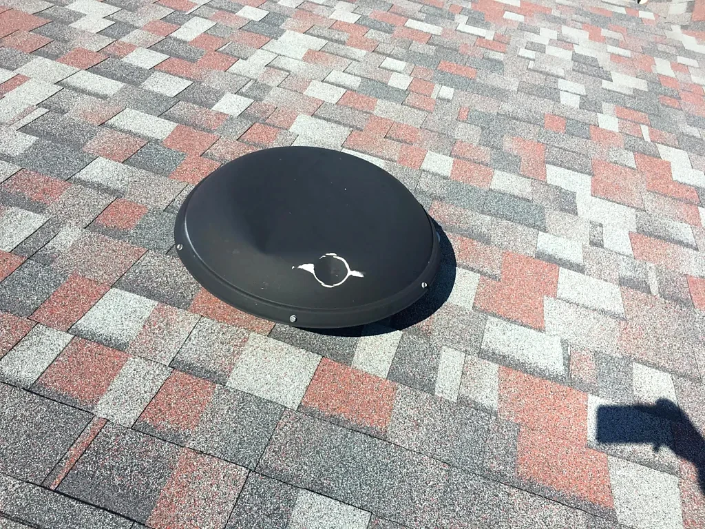 Roof covering and turbine vent before replacement.