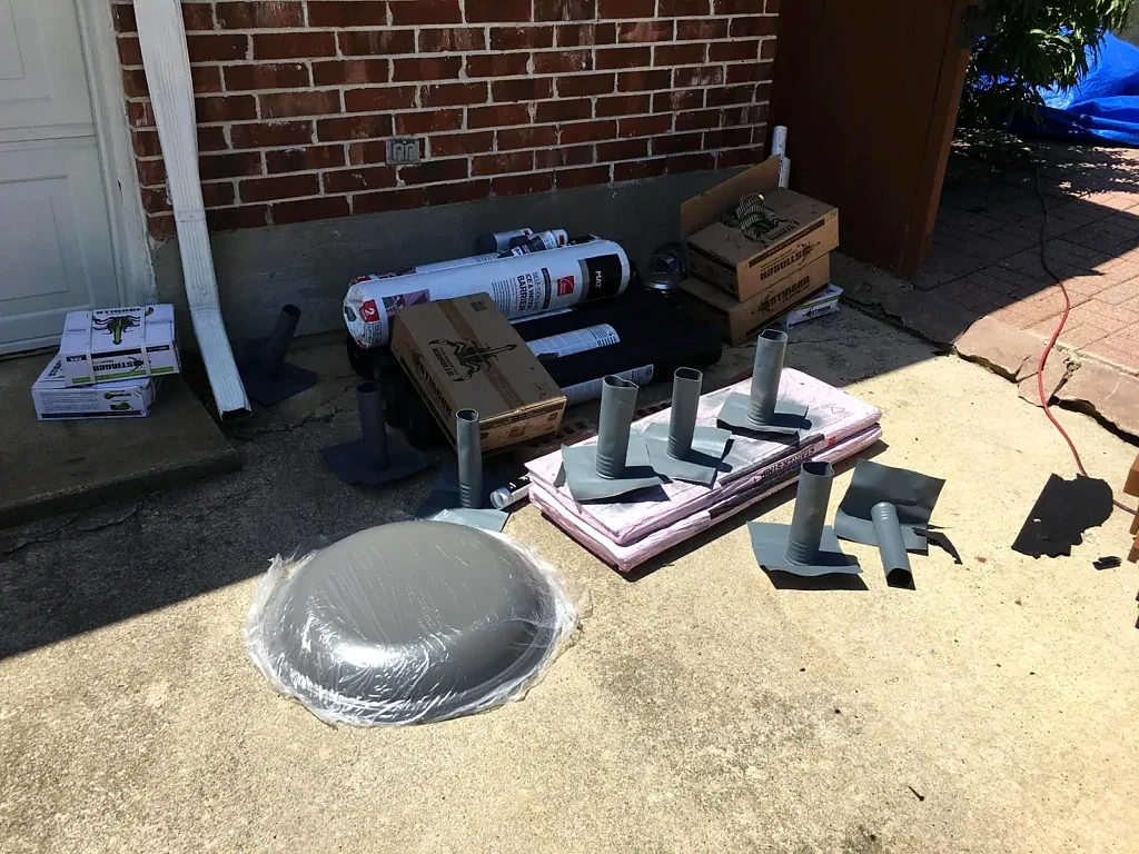 Roofing materials and components staged for installation.