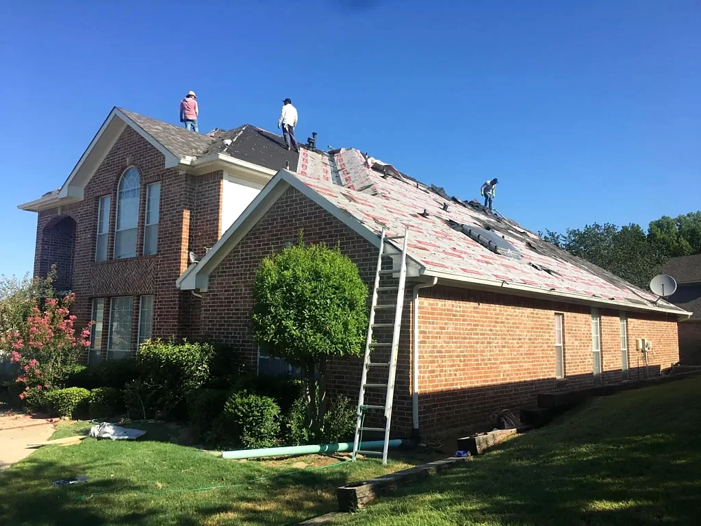 Roof installation underway above the brick exterior.