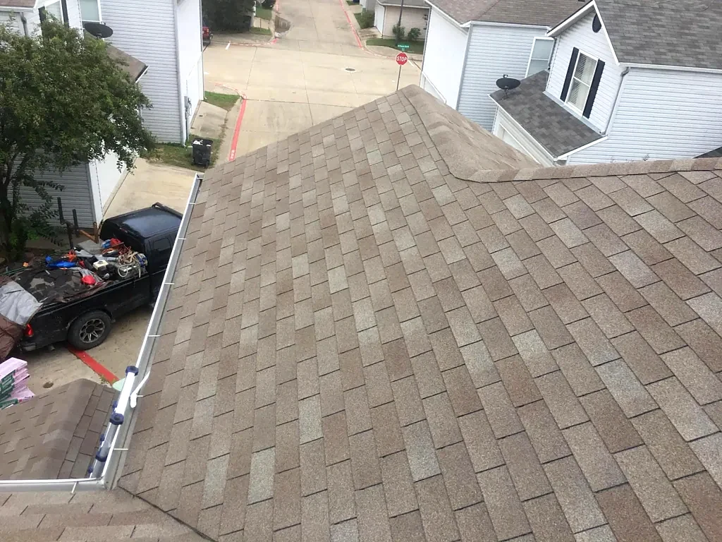 Existing shingle roof and upper wall before replacement.