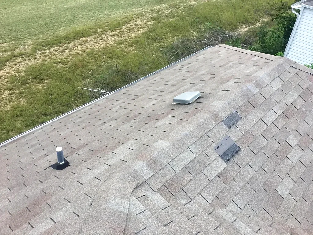 Roof slope with vent penetrations before work.