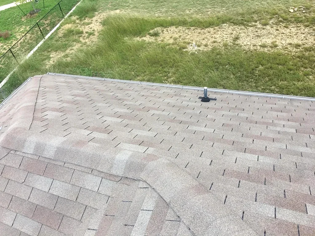 Existing ridge and shingles during inspection.