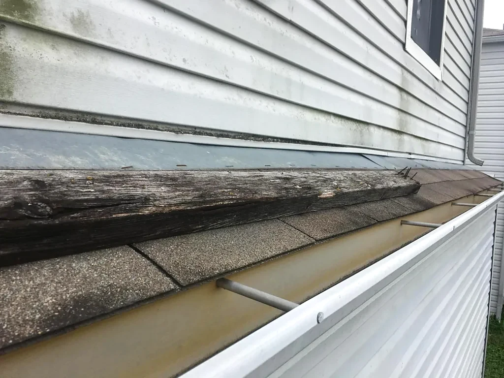Wall flashing and shingles at the lower roof.