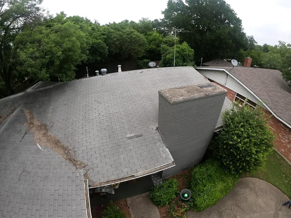 Existing roof covering around the masonry chimney.