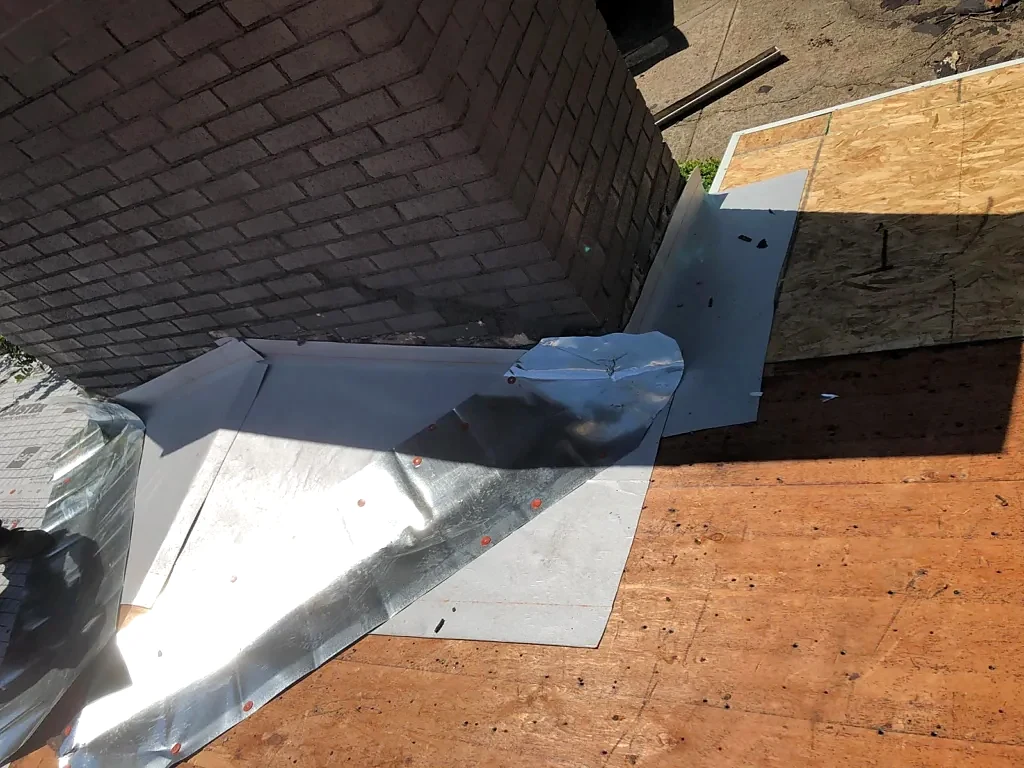 Flashing and decking around the chimney during installation.