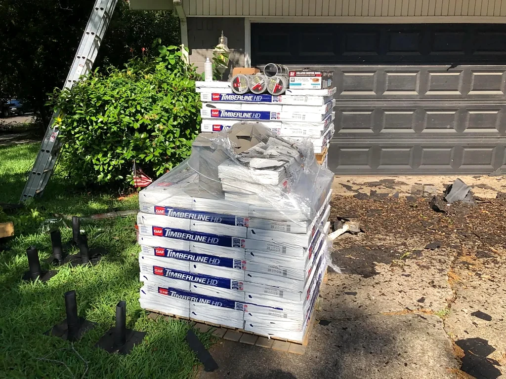 GAF shingle bundles staged for the replacement.