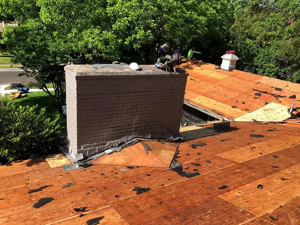 Roof decking exposed around the chimney.