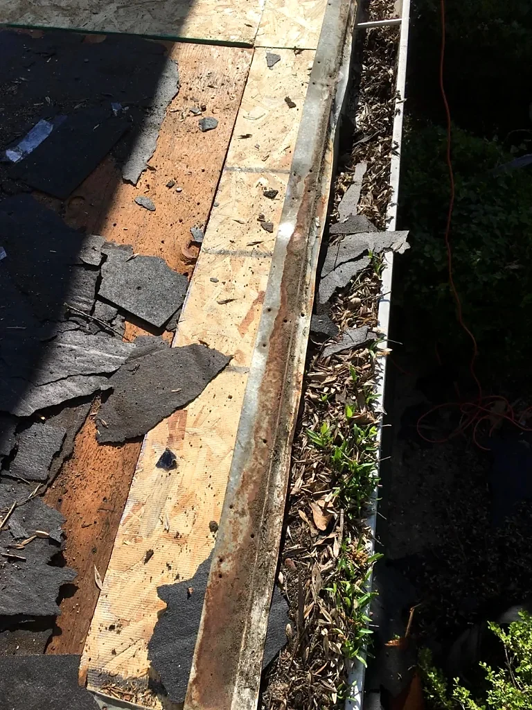Roof-edge decking detail during tear-off.