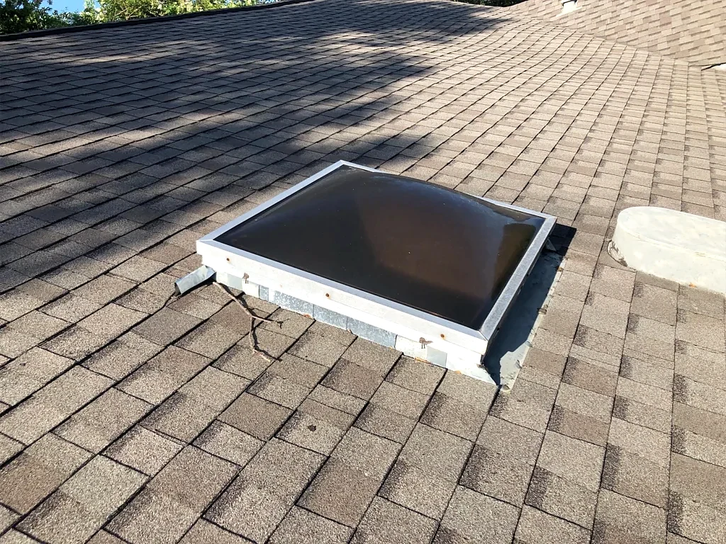 Skylight and surrounding roof before work.