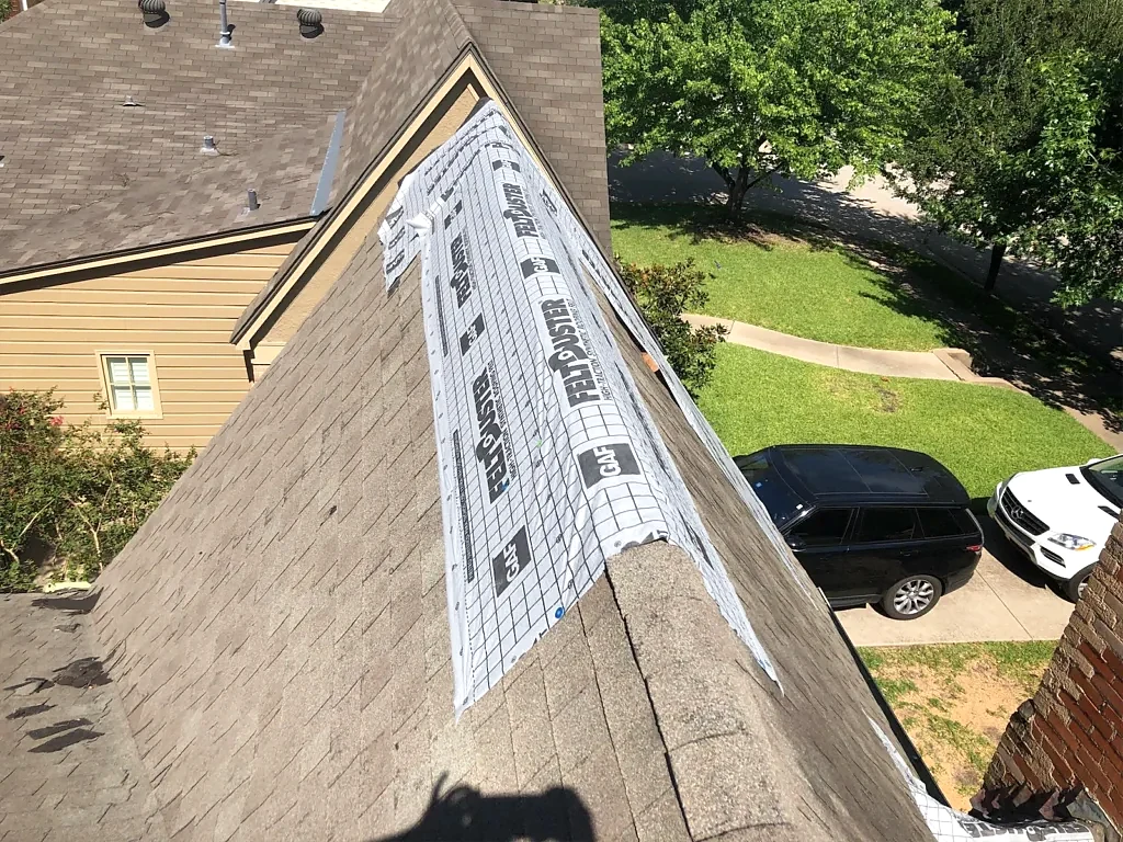 Temporary protection along an existing roof ridge.