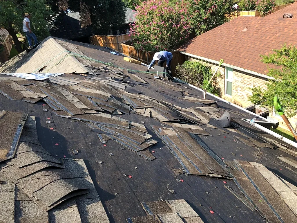 Old roofing being removed across the roof slope.