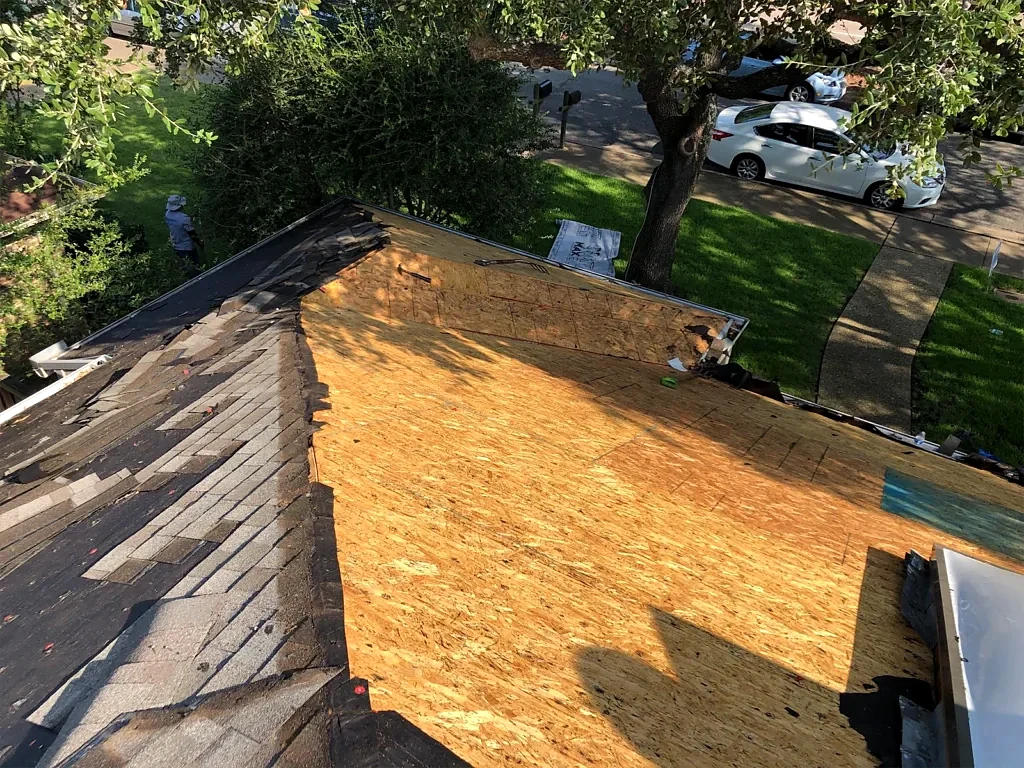 Exposed decking and roof valley during installation.