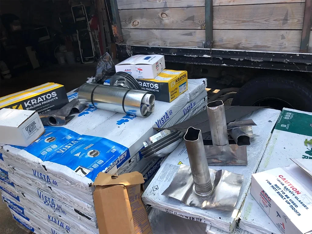 Flashing and roofing components staged for the job.