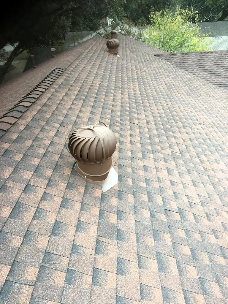 Installed shingles and turbine vents after the roof work.