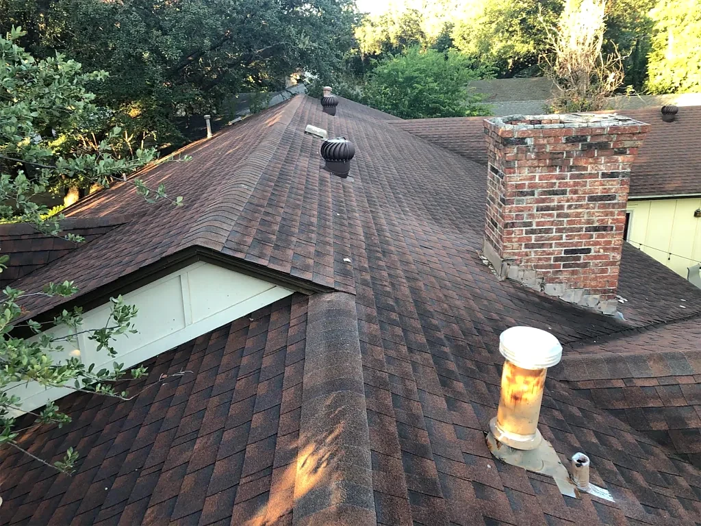 Roof intersections beside the masonry chimney.