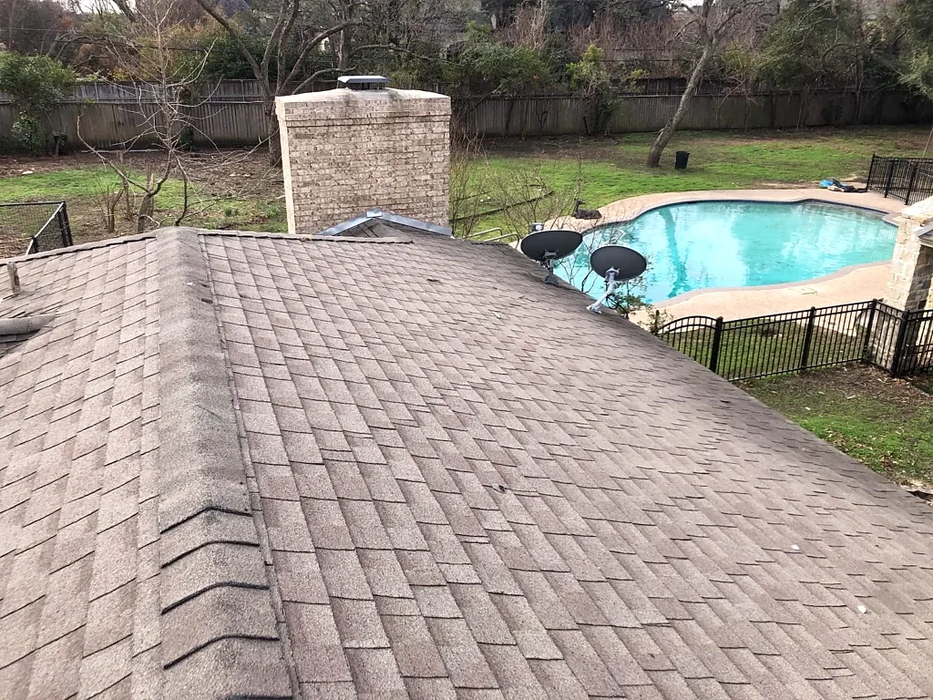 Pre-work roof view toward the masonry chimney.