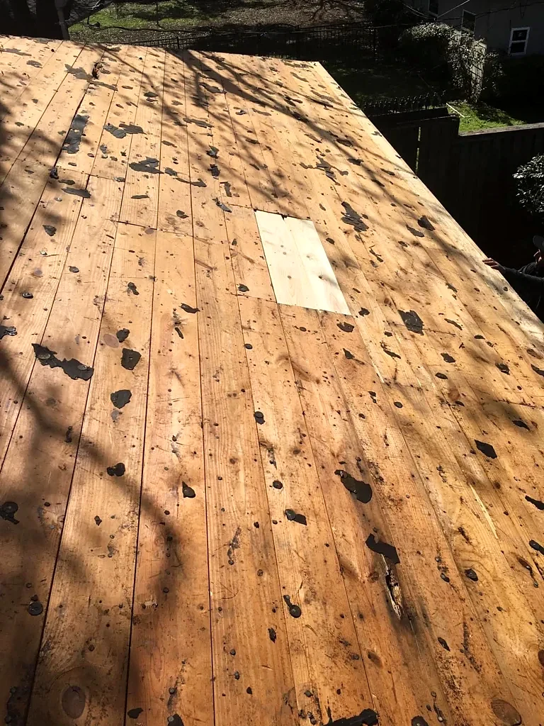 Exposed roof decking during the tear-off stage.