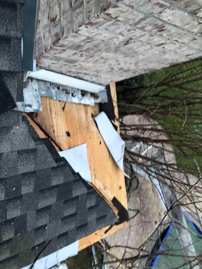 Chimney flashing and adjacent roofing during installation.