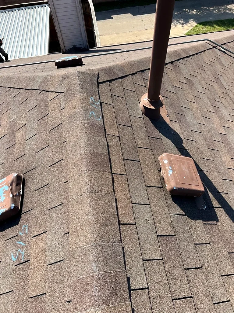 Roof-to-wall detail and vent penetration.