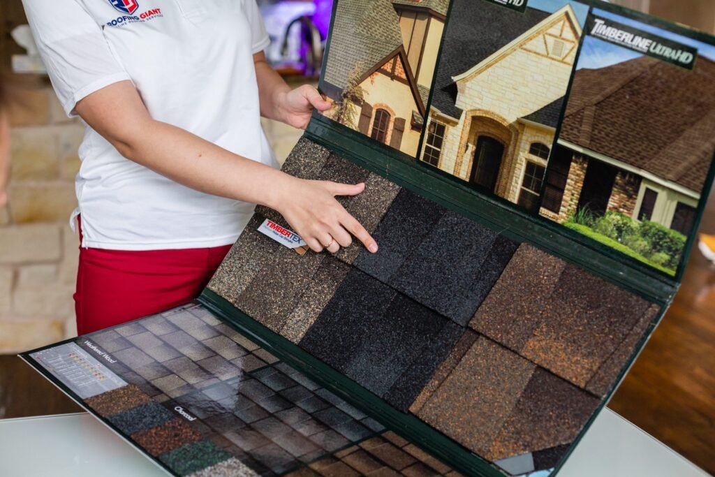Roofing Giant estimator reviewing a roof estimate on a laptop with shingle samples