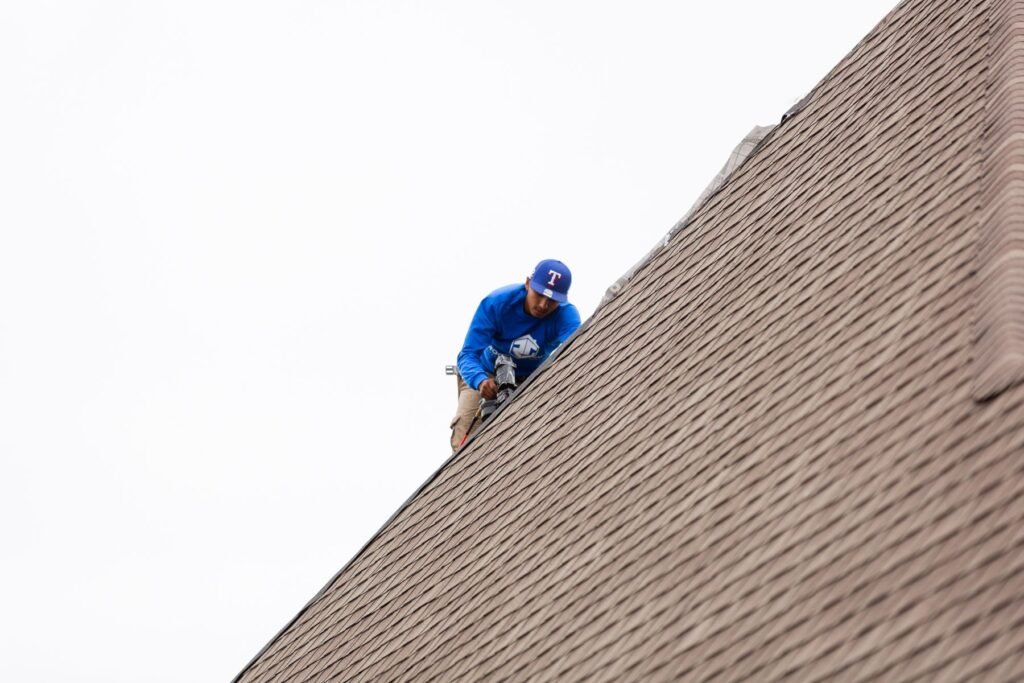 Roofing Giant inspector checking a shingle roof slope during a roof inspection