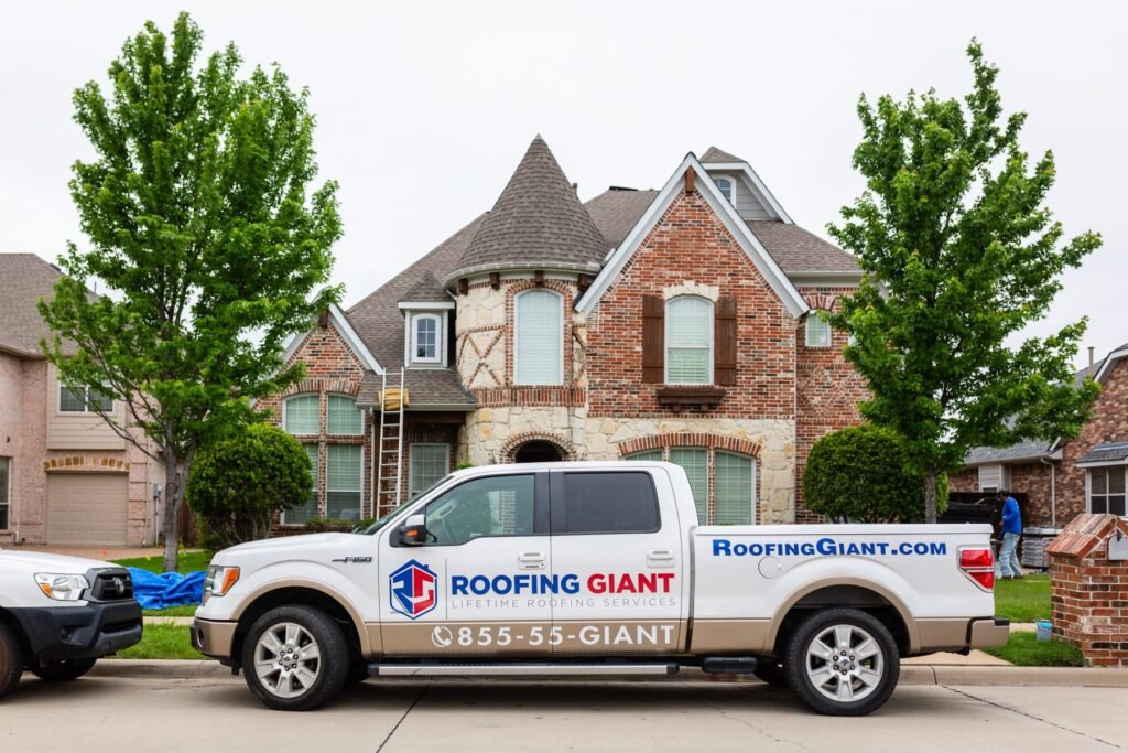 Roofing Giant roofer working along the roof edge of a Dallas home