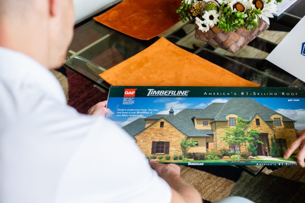 Roofing Giant specialist reviewing shingle color samples with a homeowner