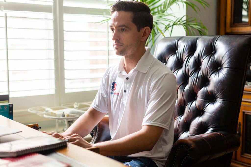 Roofing Giant team member at a desk during a customer consultation
