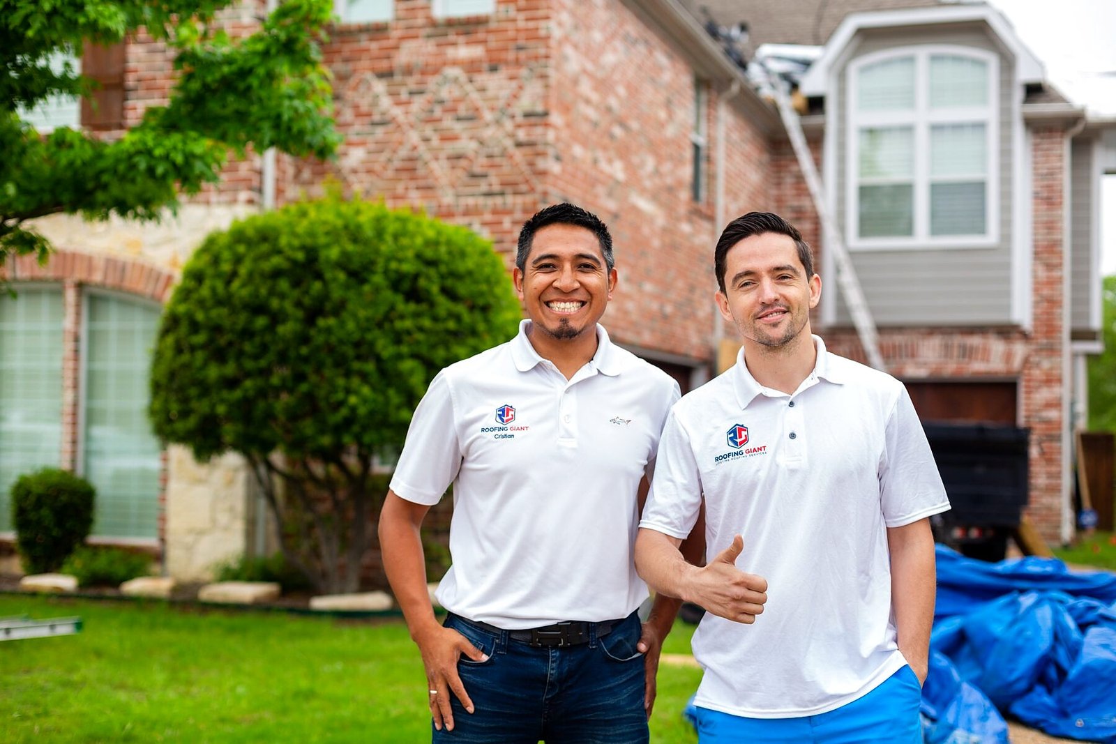 Two Roofing Giant team members in front of a Dallas–Fort Worth area home