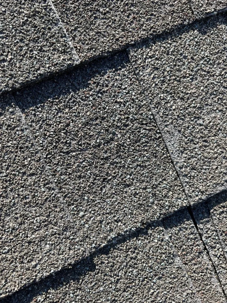 Close view of asphalt shingles recorded during the North Richland Hills roof inspection.